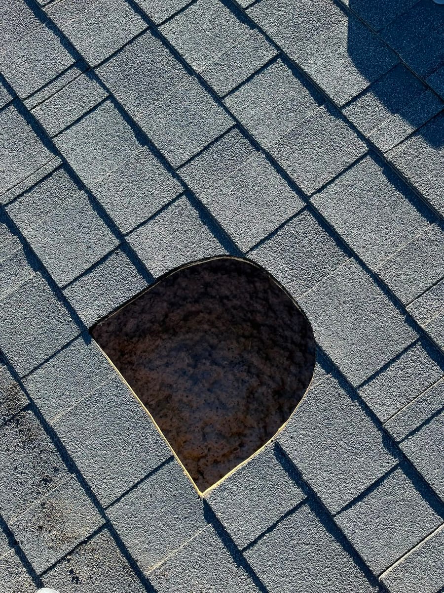 Broken concrete roof tile exposing the underlayment beneath