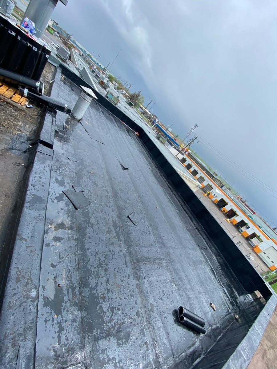 Old commercial flat roof membrane before tear-off