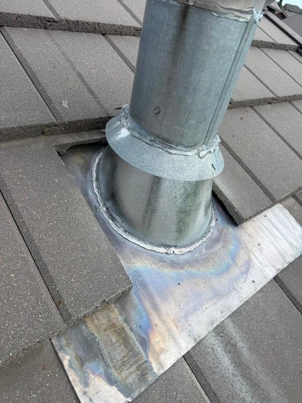 Exhaust vent metal boot repaired on a concrete tile roof