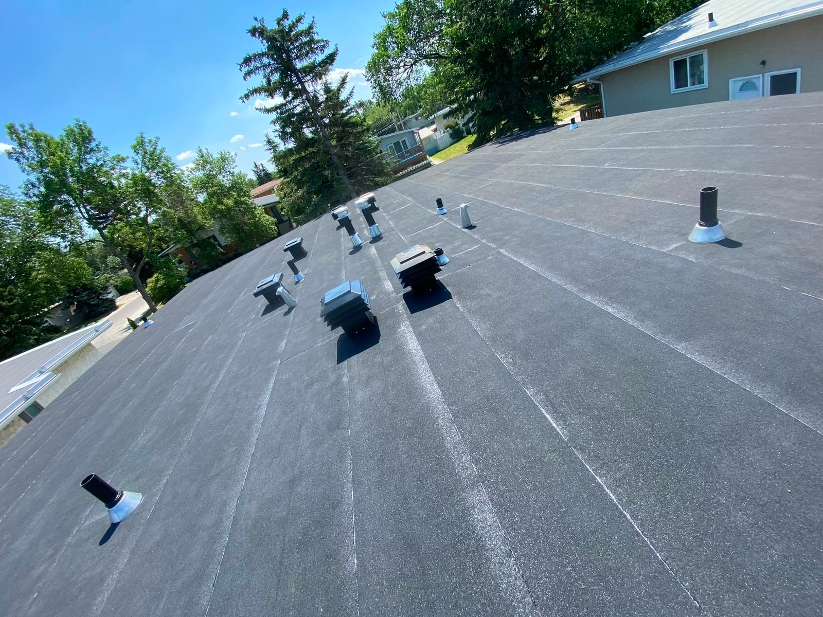 Duplex flat roof in Calgary finished with upgraded 301 maxi vents