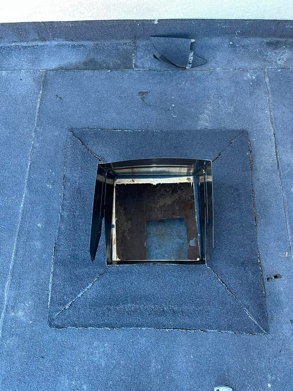 Finished SBS flashing dressed around a flat roof curb