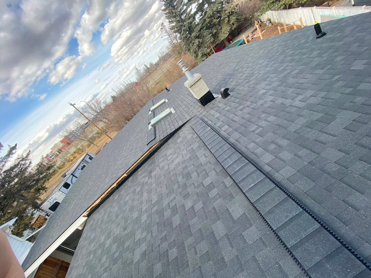 Ridge venting on a 2:12 low-slope shingled roof in Calgary