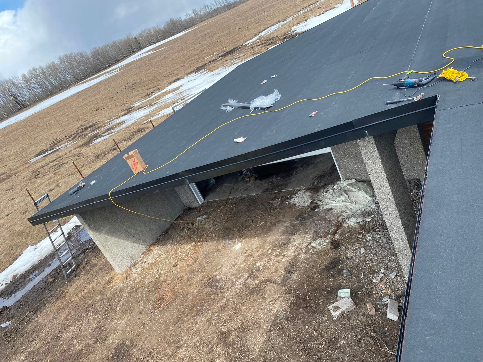 SBS base sheet and metal edge on a low-slope acreage shop roof