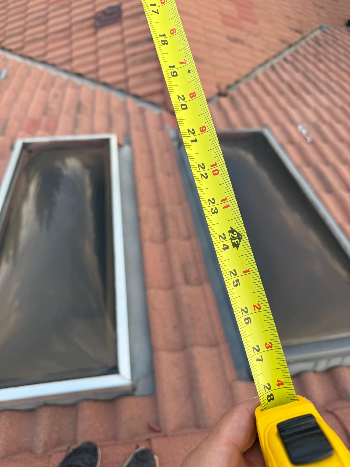 Measuring a skylight for replacement on a concrete tile roof