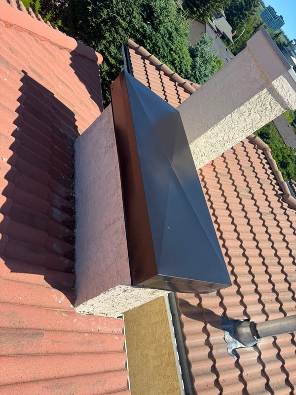 New metal chimney cap on a Calgary tile roof