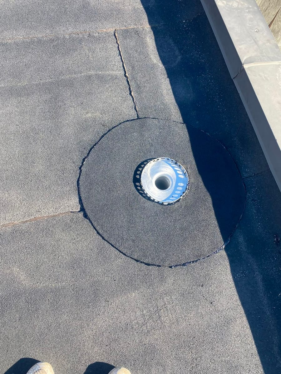 New roof drain flashed into a commercial flat roof membrane