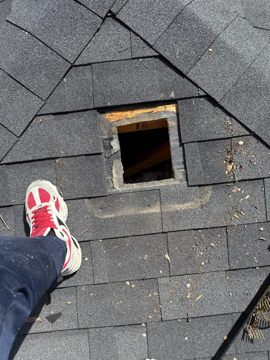 New vent opening cut into a shingle roof deck in Calgary