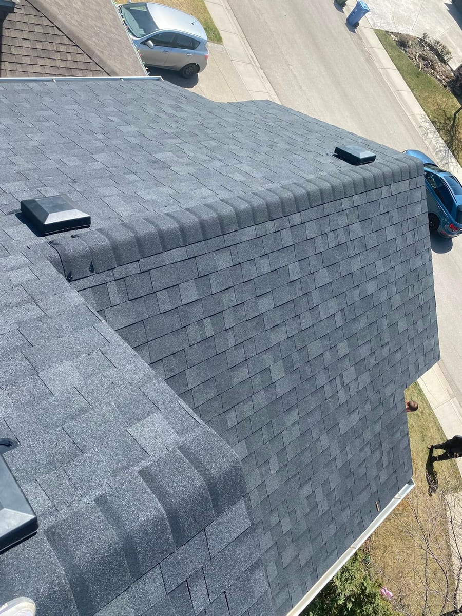 Hip and ridge cap detail on a finished shingle roof