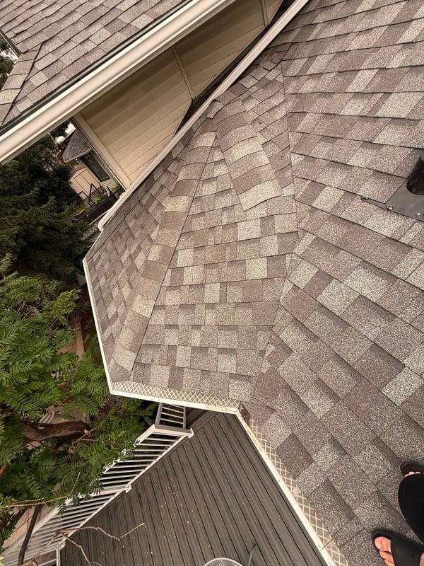 New shingle roof valley running into the eavestrough