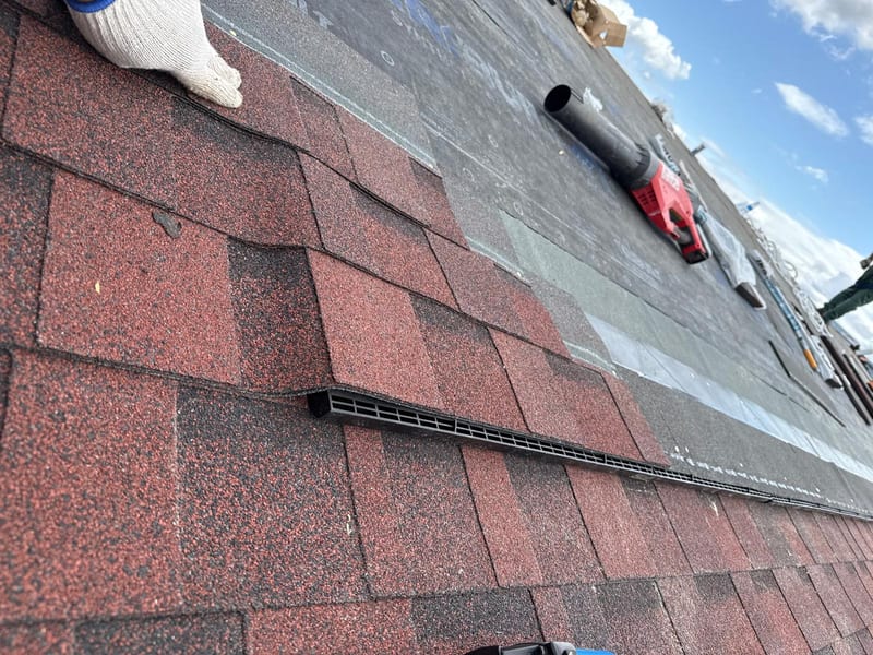 Ridge vent installed along a commercial shingle roof