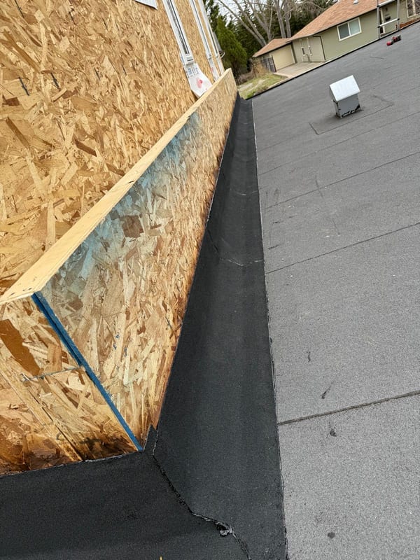 SBS base flashing carried up a parapet wall