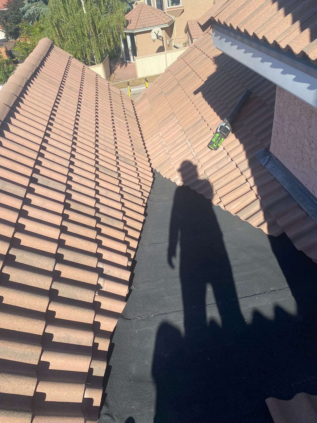 Torch-applied membrane tying a valley into a concrete tile roof